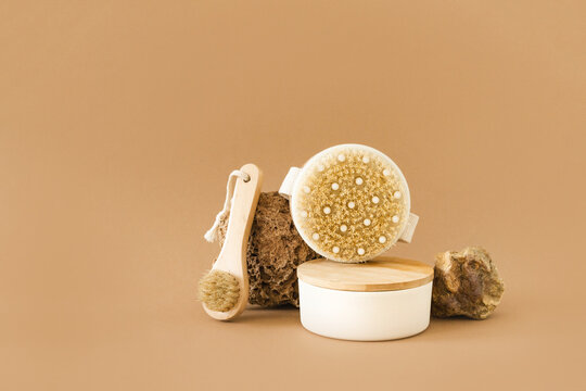 Set of natural wood brushes and spa accessories for body exfoliation and facial cleansing, beige background. Organic spa care, eco-beauty concept