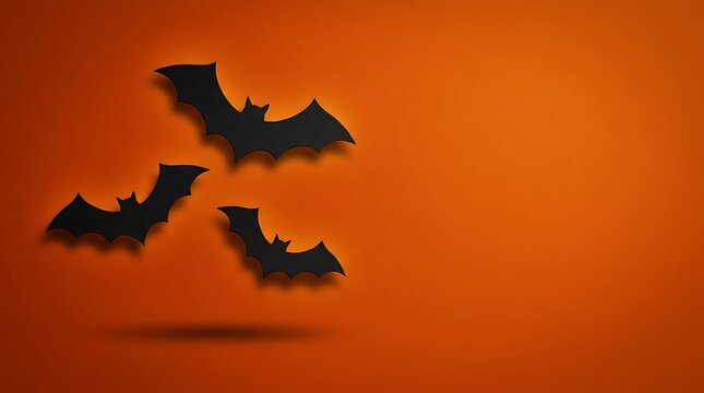 Halloween bats paper cutout spooky orange background for october 31st