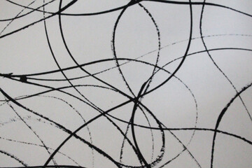 Obraz premium Abstract black and white background featuring an intricate composition of hand-drawn curved lines and overlapping circular strokes. Modern artistic texture suitable for branding, textile prints