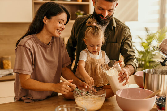 Happy family baking together in modern kitchen