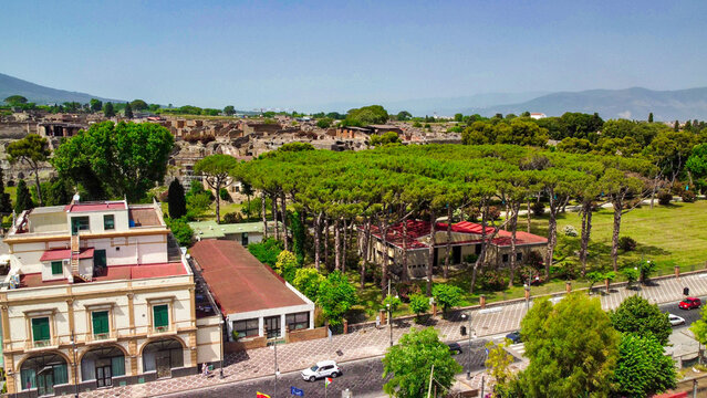 Cinematic aerial view of Pompeii ancient streets and excavated Roman city remains