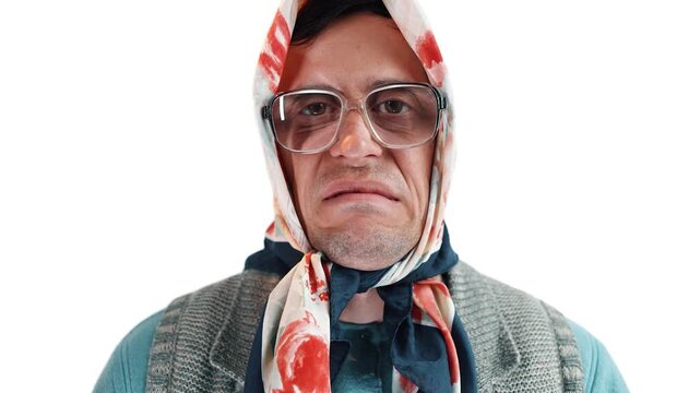 Cross dressing actor as old grandma making a highly dissatisfied annoyed face
