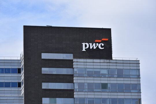 PWC PriceWaterhouseCoopers company office with logo, signage on the facade. WARSAW, POLAND - APRIL 30, 2026