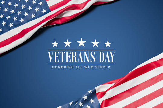 Two wrinkled flags of the USA draped onto a flat dark blue surface and the text "Veterans Day - Honoring all who served" - web banner format
