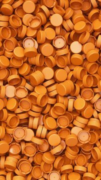 Pan across a pile of orange plastic bottle caps for recycling and plastic industry production, 3D render dynamic Vertical video.