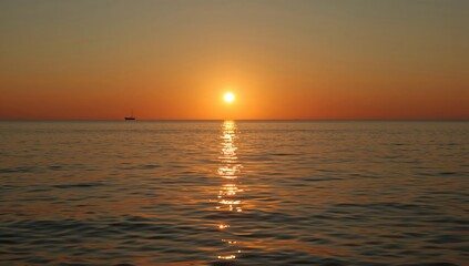 Obraz premium Sunset Over Calm Water With Boat Silhouette on Horizon at Evening