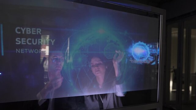 People interacting with a digital screen about cyber security technology in a modern setting