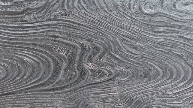 Detailed macro photograph of a silver Damascus steel surface with fine wavy lines and metallic ripple patterns