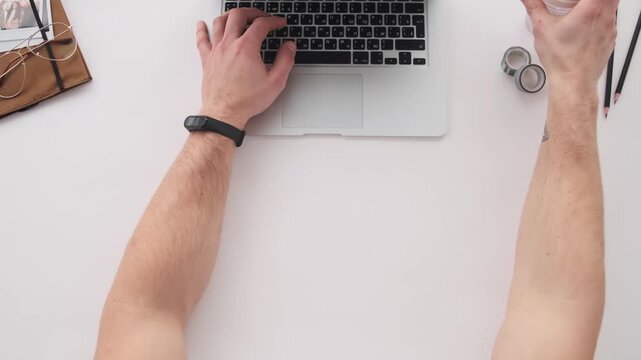Man hand taping on keyboard, man hand tapping on keyboard, top view, overhead shot, male hands typing, laptop keyboard, office work, home office, professional setting, close up, desk view, coffee cup,
