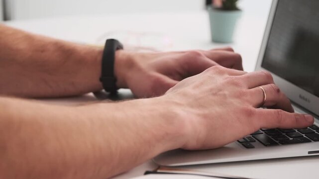 Side view, male hands typing, laptop keyboard, office work, home office, professional setting, close up, desk view, 