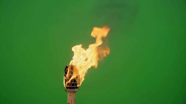 Flaring natural gas in a controlled burn against a green screen during industrial process