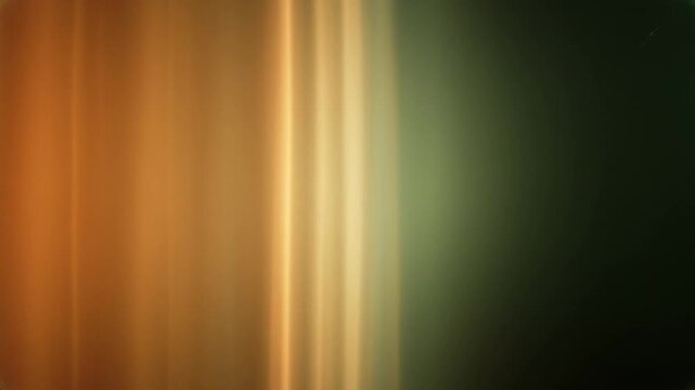 Warm orange and green light streaks with subtle motion during a soft focus transition