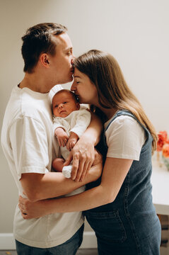 Mother and dad hugs their  sleeping newborn baby