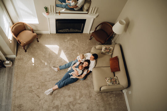 Top view of a happy family with two children in a cozy living room.