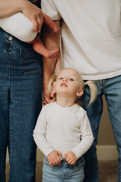 The girl is standing next to her parents.