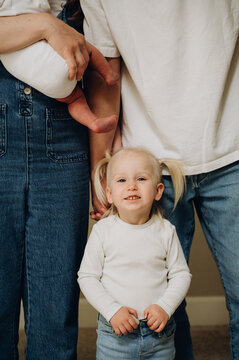 The girl is standing next to her parents.