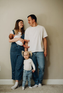 The girl is standing next to her parents.
