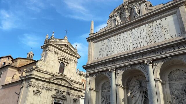 Rome, Italy Historic Catholic church facade with Latin inscription and stone arches in Rome Italy under blue sky close up famous European architecture travel video