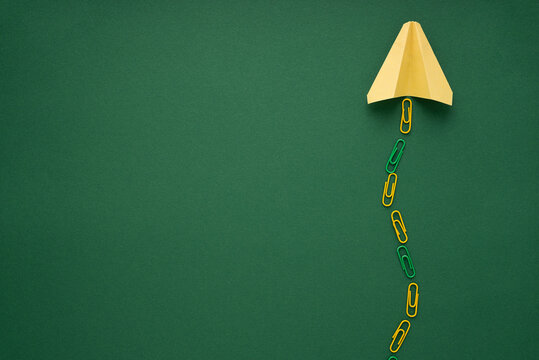 Paper plane flying up forming success path to education