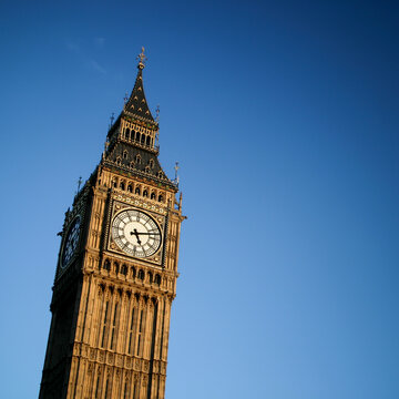 Big Ben Clock Tower. Low angle view of the famous London landmark standing against a clear blue sky.