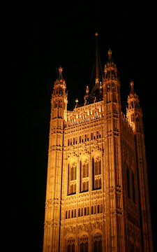 Central Tower Of Parliament. Low angle view of historic palace architecture illuminated against a dark night sky.