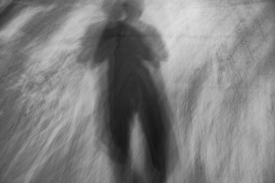 Black and white artistic shadow of a pedestrian