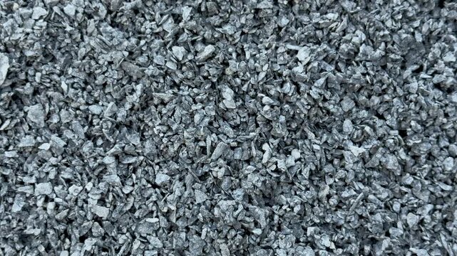 Closeup view of textured gray gravel stones creating a rough and natural surface pattern