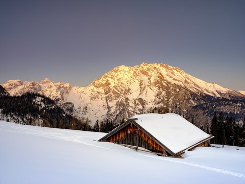 Snowy Priesbergalm in front of Watzmann east face at sunrise, Berchtesgaden Alps, Berchtesgaden National Park, Sch&ouml;nau am K&ouml;nigssee, Berchtesgadener Land, Upper Bavaria, Bavaria, Germany