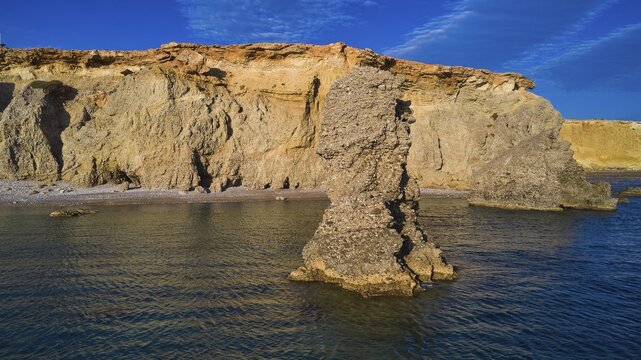 Striking rocky outcrops on a calm blue coast, drone shot, evening light, Araki Beach, southwest coast, Karpathos, Dodecanese, Greek Islands, Greece