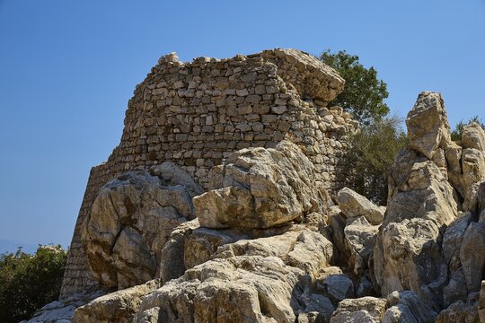 Powerful rock formations surrounded by stone ruins in a deserted landscape, Lost Place, Abandoned Village, Micro Chorio, Church of the Assumption of Mary, Zero Waste Island, Tilos, Dodecanese, Greek Islands, Greece