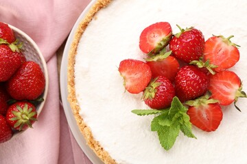 Naklejka premium Yummy cheesecake with strawberries and mint on table, flat lay
