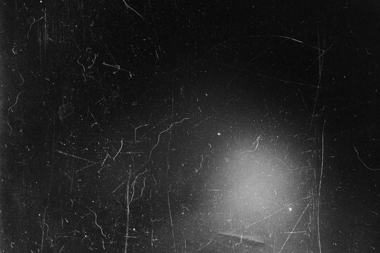 Gritty black analog overlay with heavy dust marks and bottom center light flash