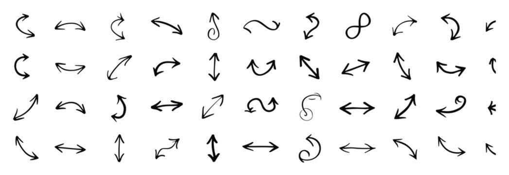 Collection of various hand drawn black arrow symbols and signs indicating direction and movement on a white background