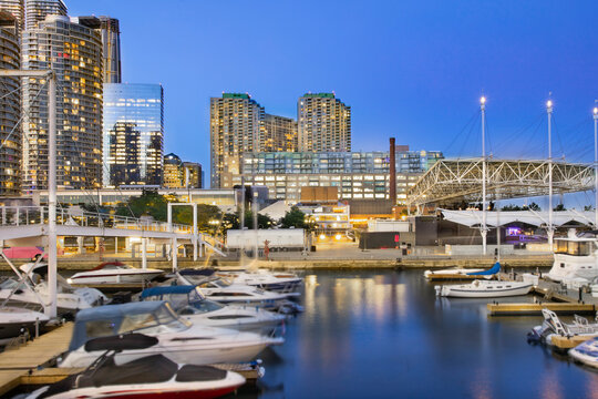 Toronto Harbourfront marina at dusk with residential and office towers in the background