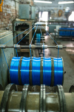 Industrial spools with blue plastic filament in a Bhavnagar factory.