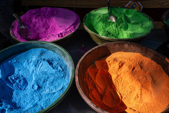 Colorful Gulal powders in large bowls for Holi festival