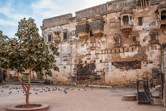 Historic stone facade and courtyard of Aina Mahal palace in Bhuj