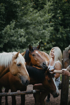 A woman with white hair next to a horse with a white mane. Concept of hair strength and health.