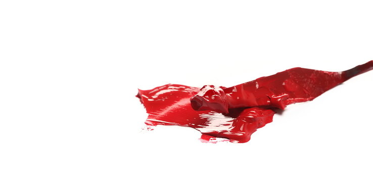 Metal spatula and red brush strokes oil paint isolated on white background, side view