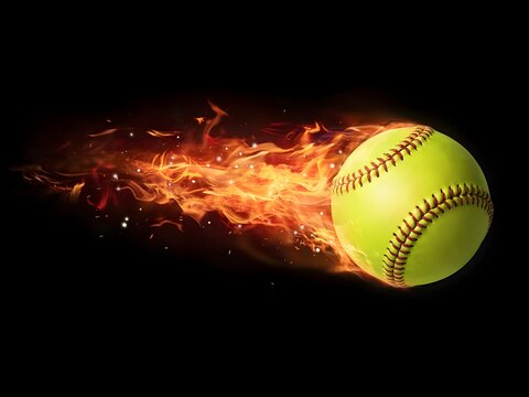 Flaming yellow softball flying with fire trail for sports design and energy concept, isolated on black background