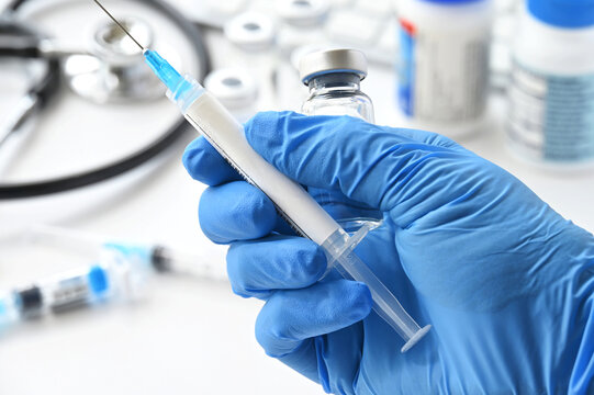 A syringe needle with generic vaccine booster with blank label - mock up copy space