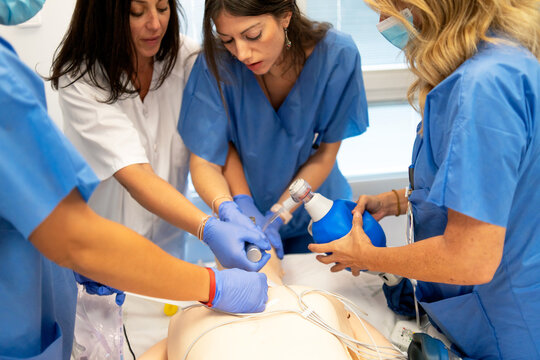 Medical students gaining practical skills on a medical mannequin
