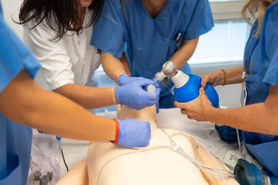 Medical team practicing cpr and intubation on training dummy