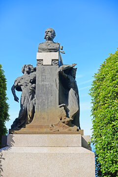 Monument with bronze buste of king Umberto I with allegoric figures on a bright spring day in Stresa, Lago Maggiore, Italy