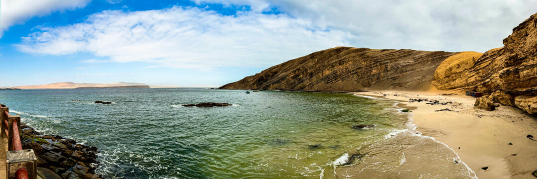 Peru, South America: breathtaking aerial and panoramic view of Playa La Mina (Mine Beach), hidden gem in the Paracas National Reserve famous for crystal-clear turquoise waters, white sand and cliffs