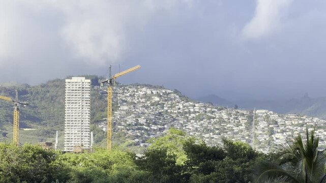 Cumulus congestus. City of Honolulu, Oahu, Hawaii. Trade Wind. Tower crane at a construction site