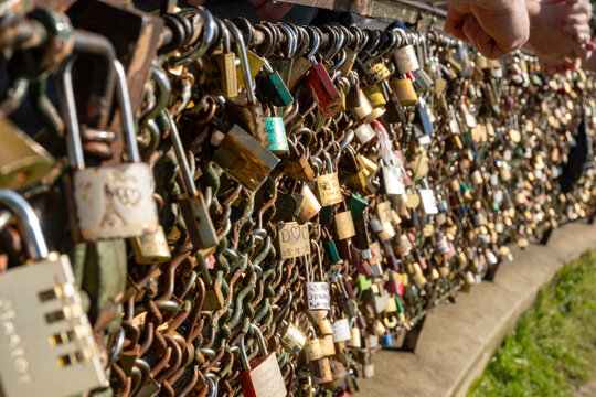 Thousands of love locks cadenas d'amour covering metal surfaces on Montmartre's bridge, symbolizing eternal commitment, marriage vows, and romantic devotion, Parisian tradition