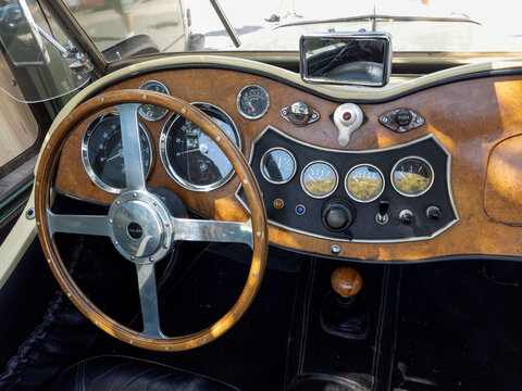 TAVERNES BLANQUES, SPAIN - JUNE 14, 2026.Classic MG TD roadster dashboard showing wood design and Moto Lita steering wheel with analogue gauges and controls
