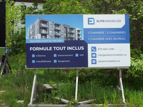 Gatineau,Quebec, Canada &ndash; May 24, 2026: An advertising sign for Elite Immobilier promotes a "Formule tout inclus" residential building offering various apartment layouts and convenient amenities on Ch