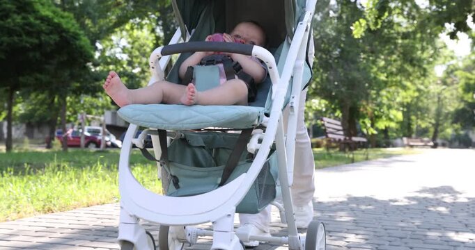 Baby carriage. Mother walking with her child in stroller outdoors